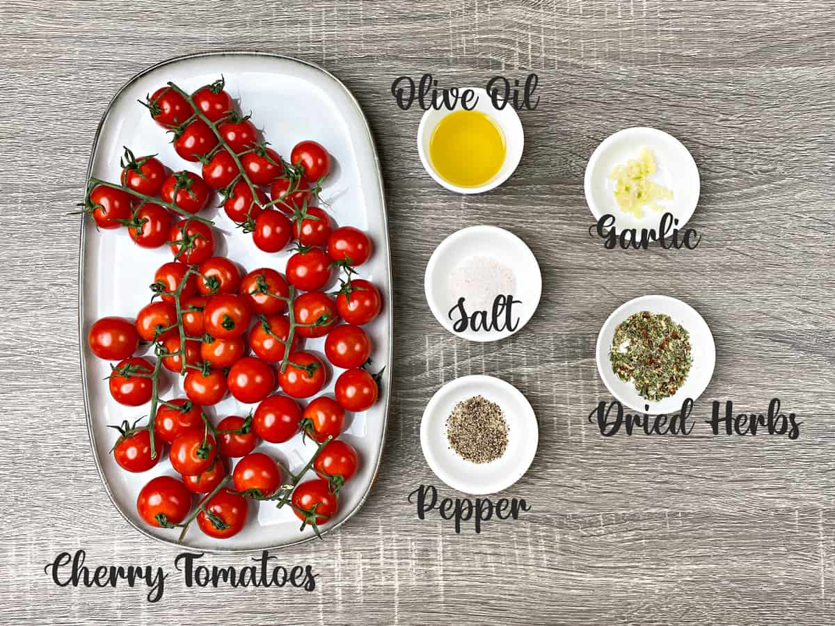 ingredients for making roasted cherry tomatoes placed in bowls